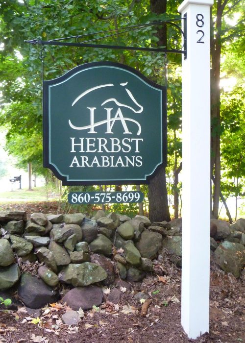 Hand-carved farm sign — an example of custom design work by New England Sign Carvers